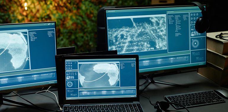 two-computer-monitors-and-laptop-with-information-2025-03-07-15-17-57-utc